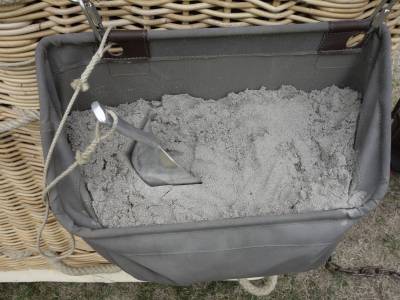Sandbag with a shovel outside of the basket.
